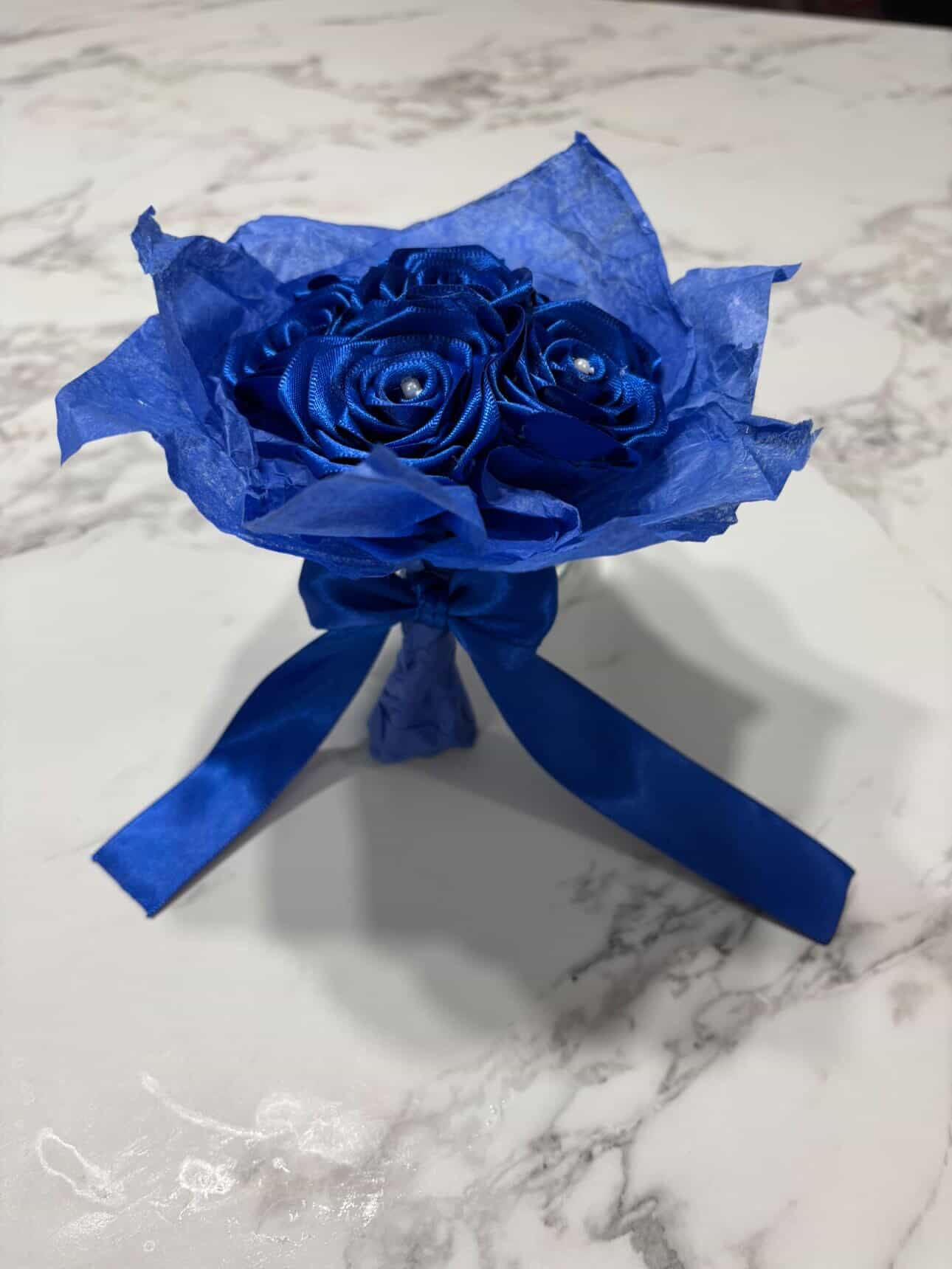 Blue ribbon rose mini bouquet tied with satin ribbon
